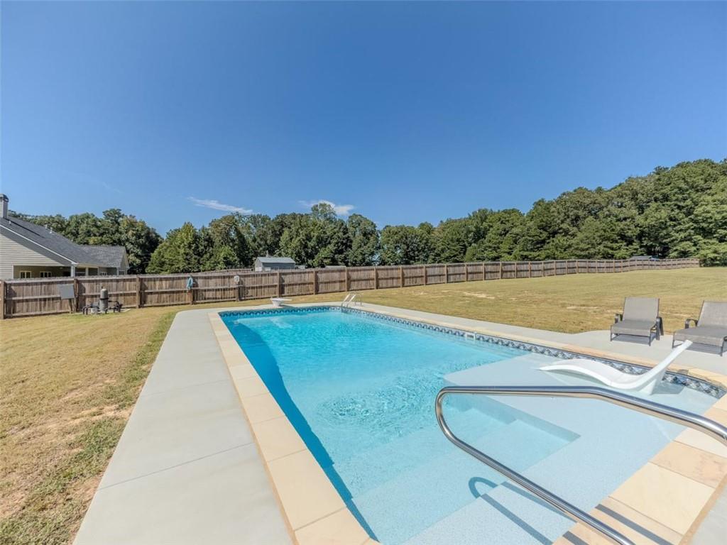 710 Poplar Street Monroe, GA 30655 - Photo 5 of 60 a view of swimming pool with a lounge chair