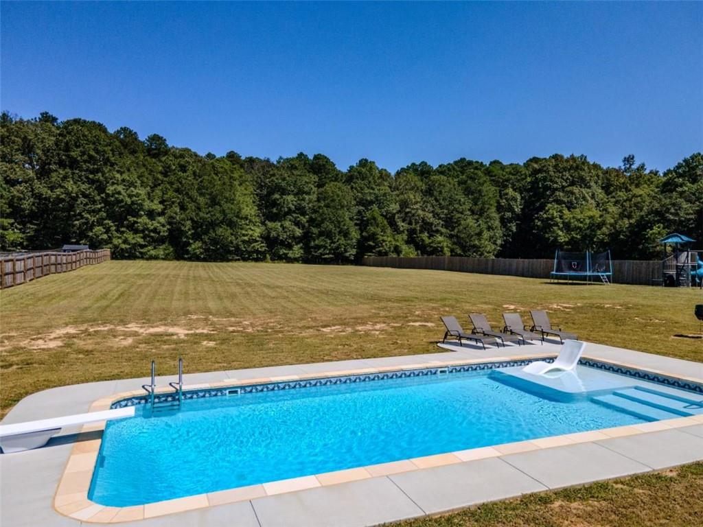 710 Poplar Street Monroe, GA 30655 - Photo 52 of 60 a view of a swimming pool and an outdoor seating