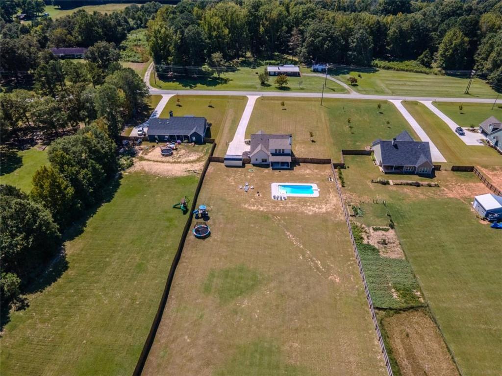 710 Poplar Street Monroe, GA 30655 - Photo 55 of 60 a view of a swimming pool with a yard and plants