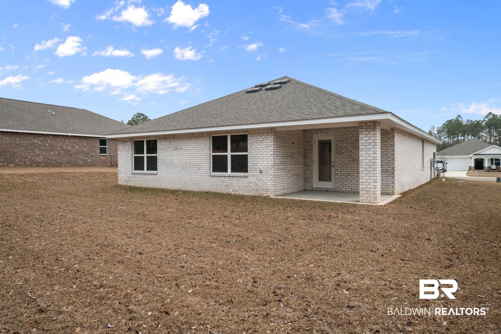 16272 Laurelbrooke Loop Fairhope, AL 36532 - Photo 25 of 40 Back of house with a yard and a patio