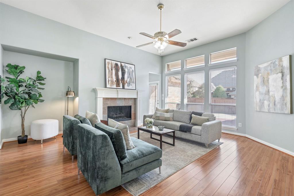 1105 Lamplight Way Allen, TX 75013 - Photo 11 of 40 a living room with furniture fireplace and a large window