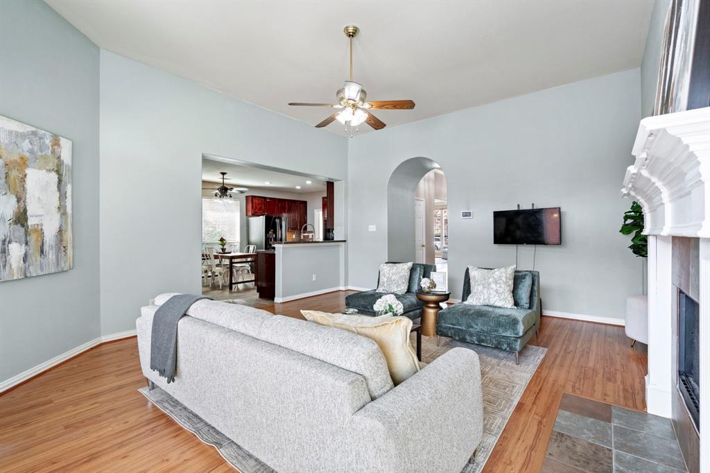 1105 Lamplight Way Allen, TX 75013 - Photo 13 of 40 a living room with furniture a chandelier and a flat screen tv