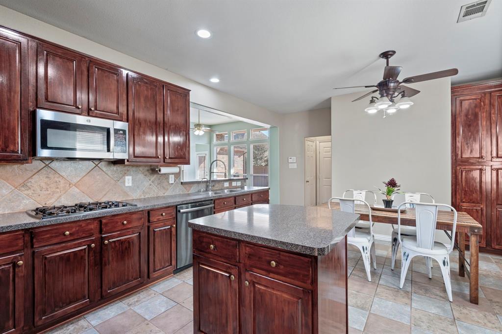 1105 Lamplight Way Allen, TX 75013 - Photo 17 of 40 a kitchen with kitchen island granite countertop a sink counter top space appliances and cabinets