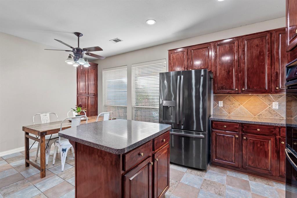 1105 Lamplight Way Allen, TX 75013 - Photo 18 of 40 a kitchen with a refrigerator sink and cabinets