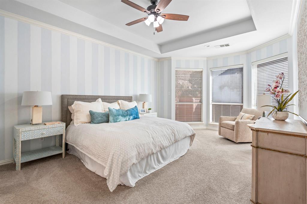 1105 Lamplight Way Allen, TX 75013 - Photo 21 of 40 a bedroom with a bed and a chandelier fan