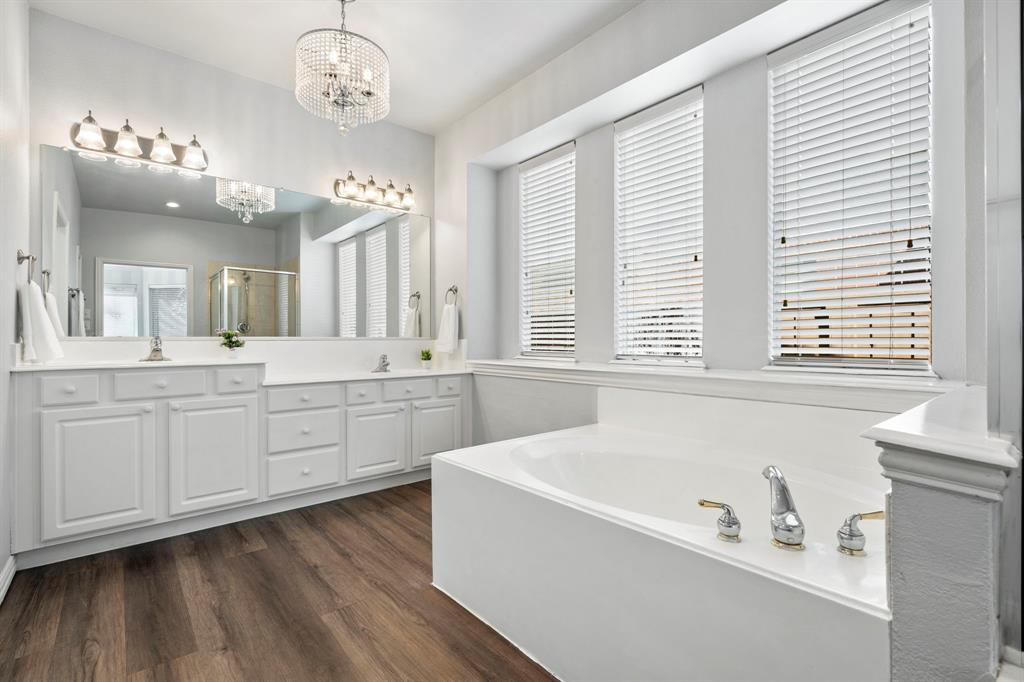 1105 Lamplight Way Allen, TX 75013 - Photo 24 of 40 a spacious bathroom with a tub a double vanity sink a window and a mirror