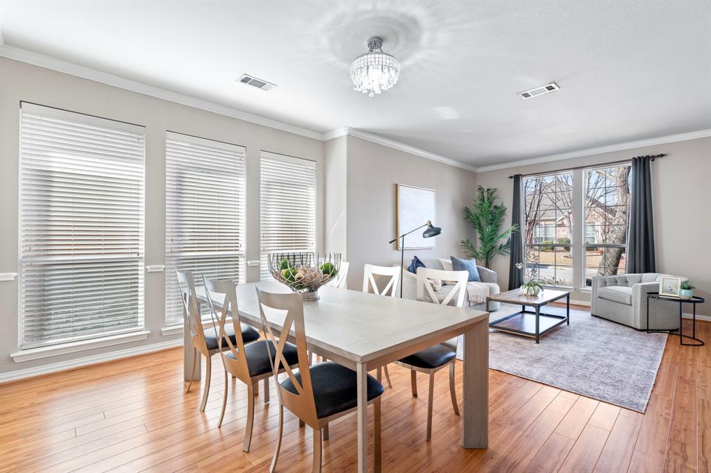 1105 Lamplight Way Allen, TX 75013 - Photo 5 of 40 a view of a dining room with furniture wooden floor and chandelier