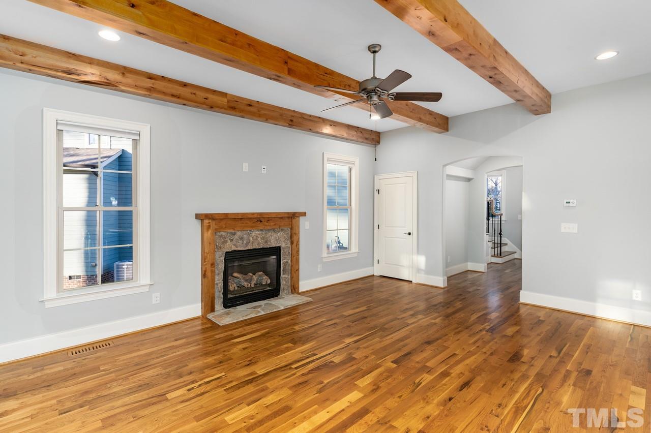 8505 Wynhurst Court Raleigh, NC 27613 - Photo 2 of 30 a view of an empty room with wooden floor fireplace and a window