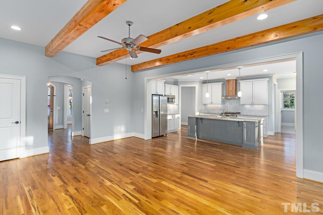 8505 Wynhurst Court Raleigh, NC 27613 - Photo 12 of 30 a view of a kitchen with kitchen island a sink wooden floor and appliances