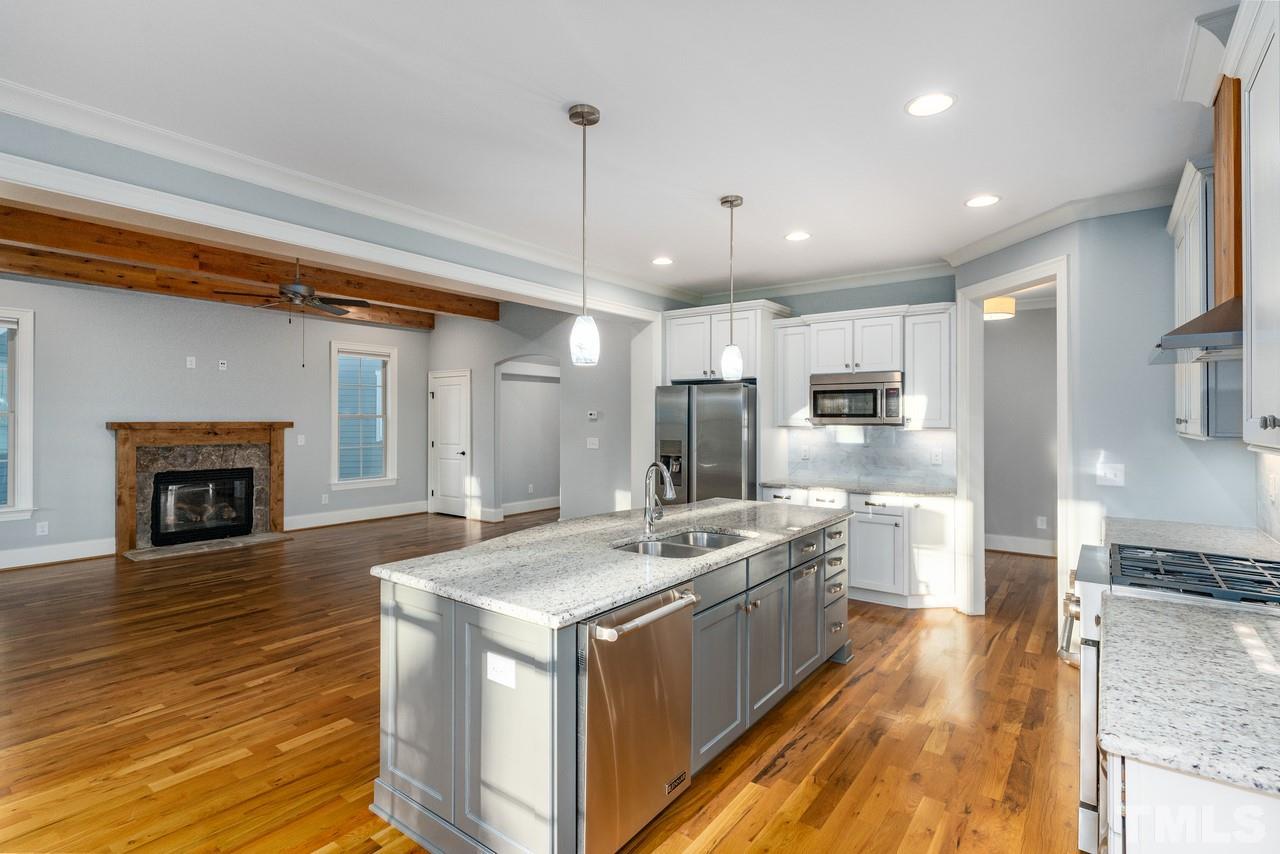 8505 Wynhurst Court Raleigh, NC 27613 - Photo 13 of 30 a kitchen with stainless steel appliances granite countertop a sink a stove and a refrigerator