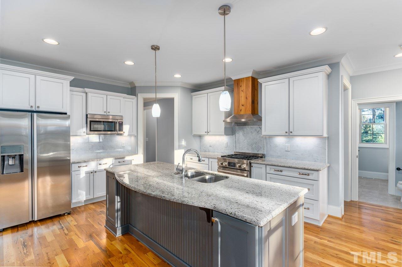 8505 Wynhurst Court Raleigh, NC 27613 - Photo 3 of 30 a kitchen with stainless steel appliances granite countertop a sink refrigerator and cabinets