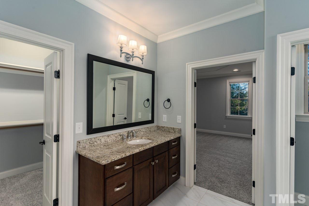 8505 Wynhurst Court Raleigh, NC 27613 - Photo 24 of 30 a bathroom with a granite countertop sink and a mirror