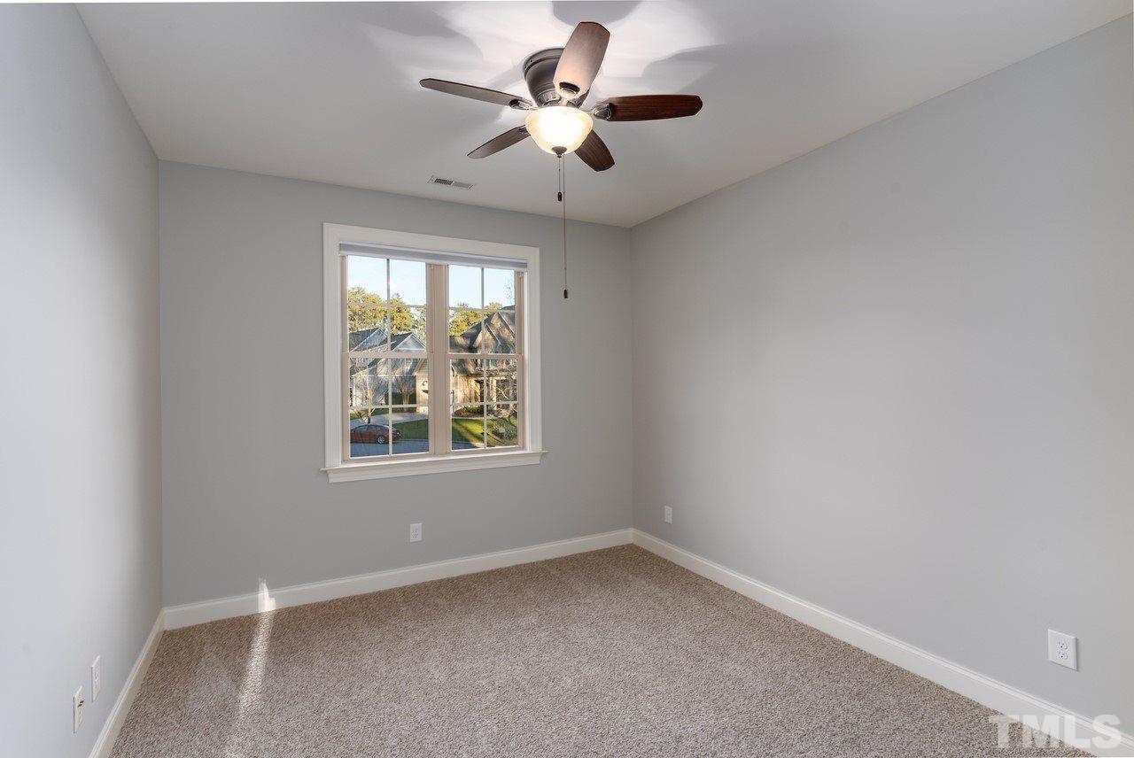 8505 Wynhurst Court Raleigh, NC 27613 - Photo 25 of 30 an empty room with a window and a fan