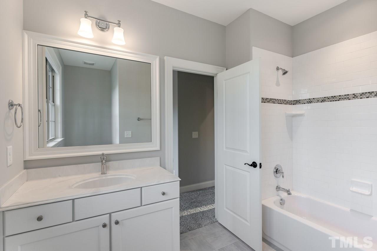 8505 Wynhurst Court Raleigh, NC 27613 - Photo 26 of 30 a bathroom with a bathtub and a sink