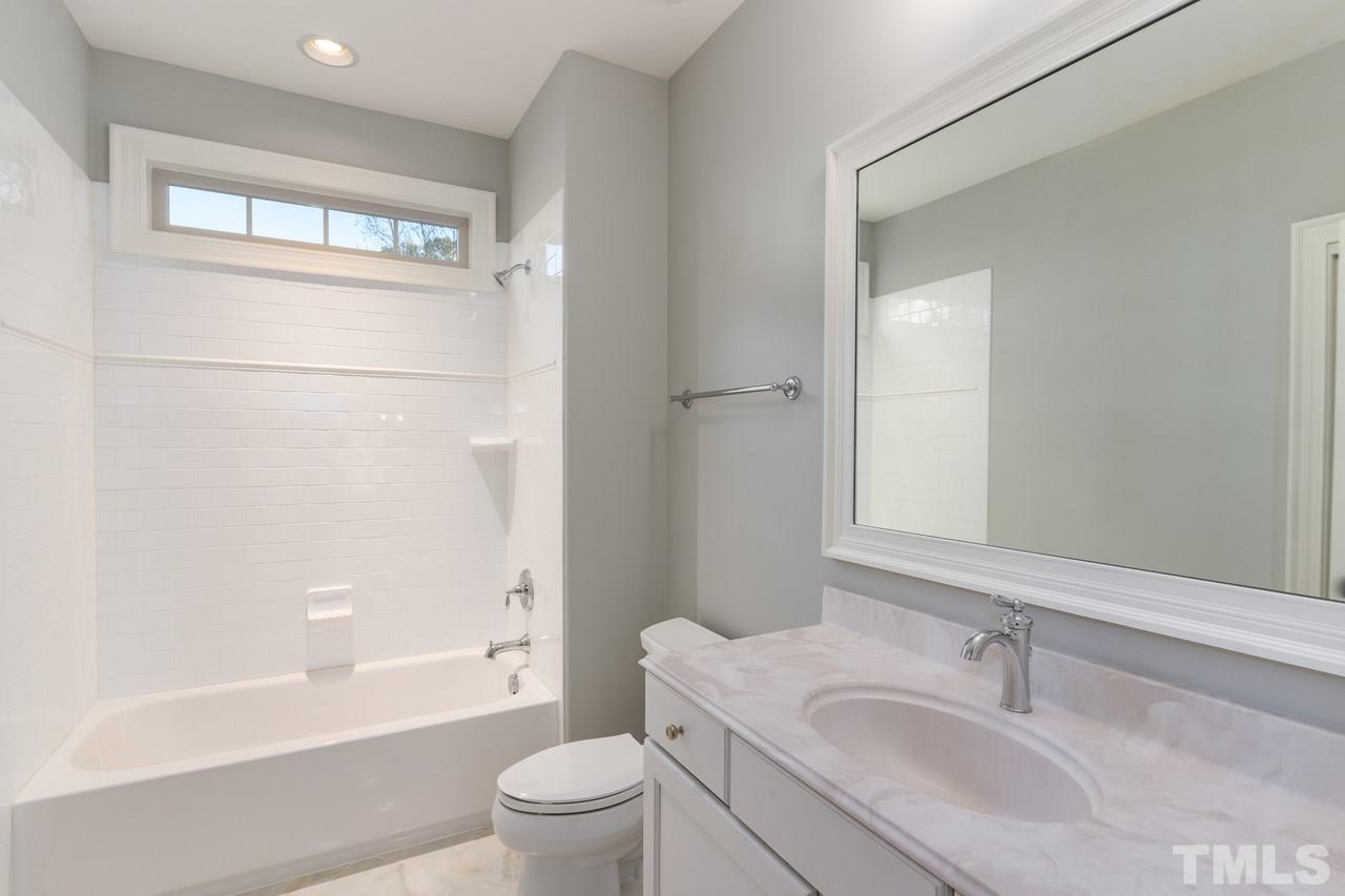 8505 Wynhurst Court Raleigh, NC 27613 - Photo 28 of 30 a bathroom with a sink toilet and shower