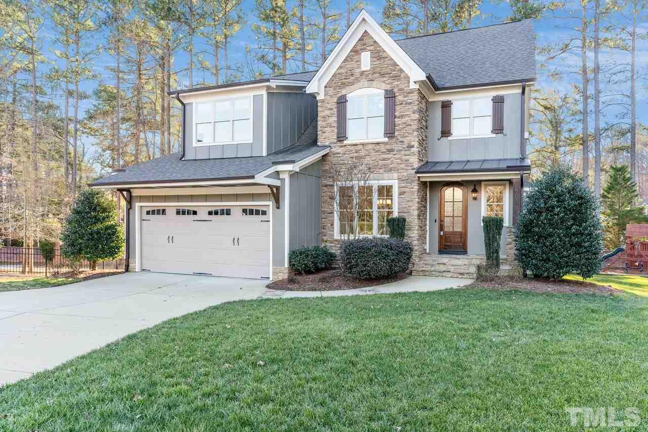 8505 Wynhurst Court Raleigh, NC 27613 - Photo 7 of 30 a front view of a house with a yard and garage