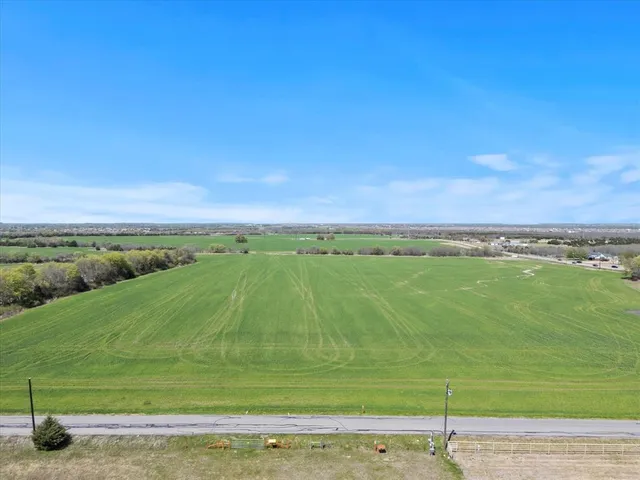 a view of a field with an ocean