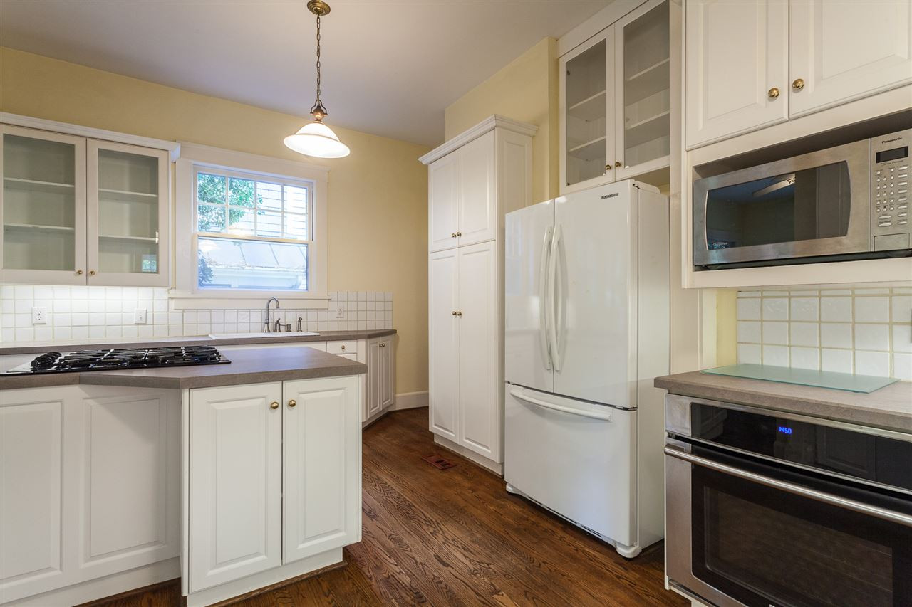 117 Forest Road Raleigh, NC 27605 - Photo 10 of 30 Hardwood Floors and Glass Accent Cabinets Kitchen