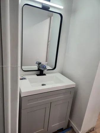 a kitchen with granite countertop a sink and a stove