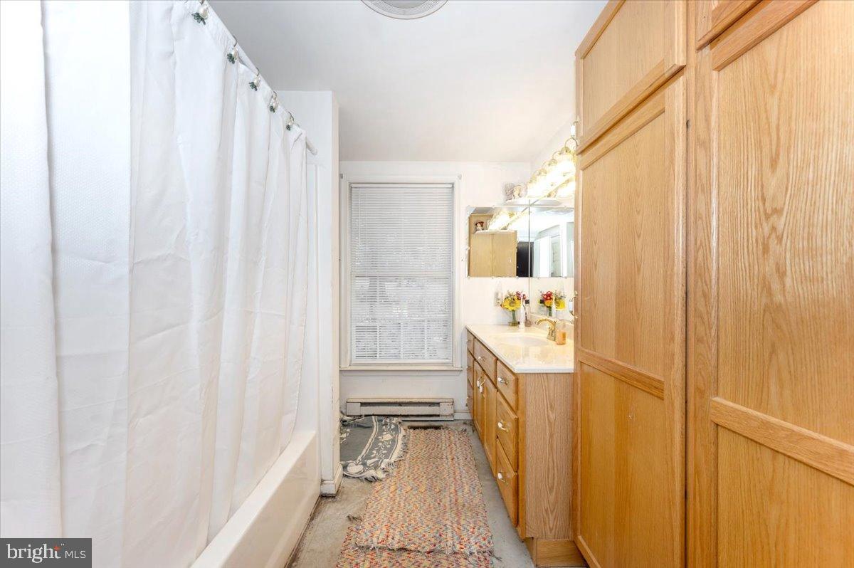 10891 Bethesda Church Road Damascus, MD 20872 - Photo 14 of 51 a bathroom with a mirror and a shower curtain