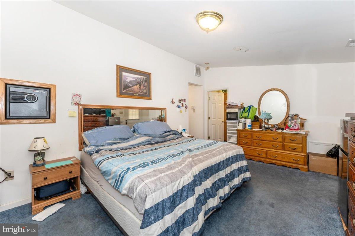 10891 Bethesda Church Road Damascus, MD 20872 - Photo 17 of 51 a bedroom with a bed and dresser