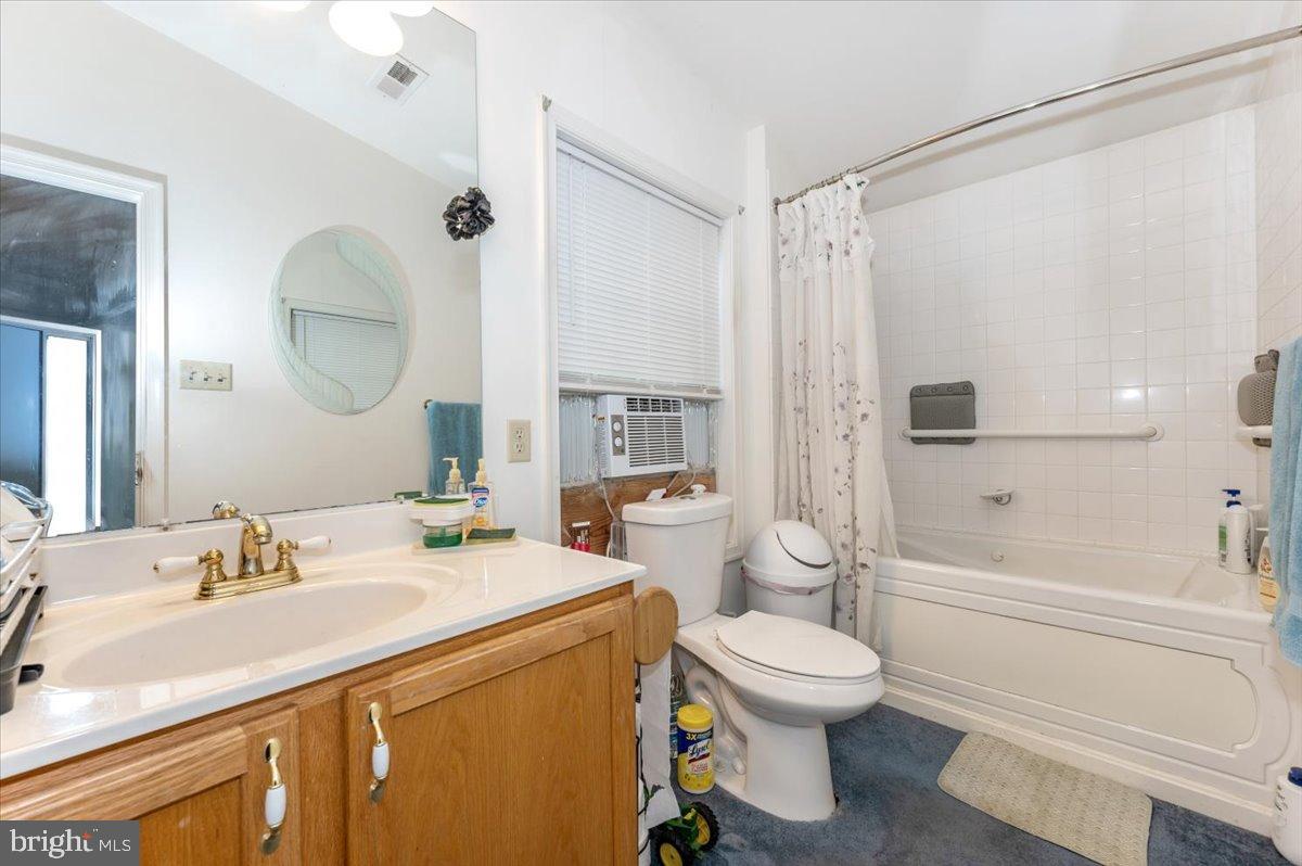 10891 Bethesda Church Road Damascus, MD 20872 - Photo 18 of 51 a bathroom with a sink a toilet and a large mirror