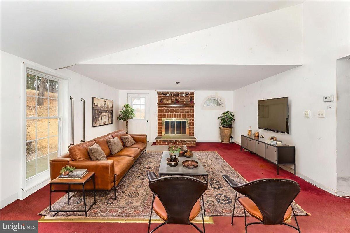 10891 Bethesda Church Road Damascus, MD 20872 - Photo 2 of 51 a living room with furniture a rug and a flat screen tv