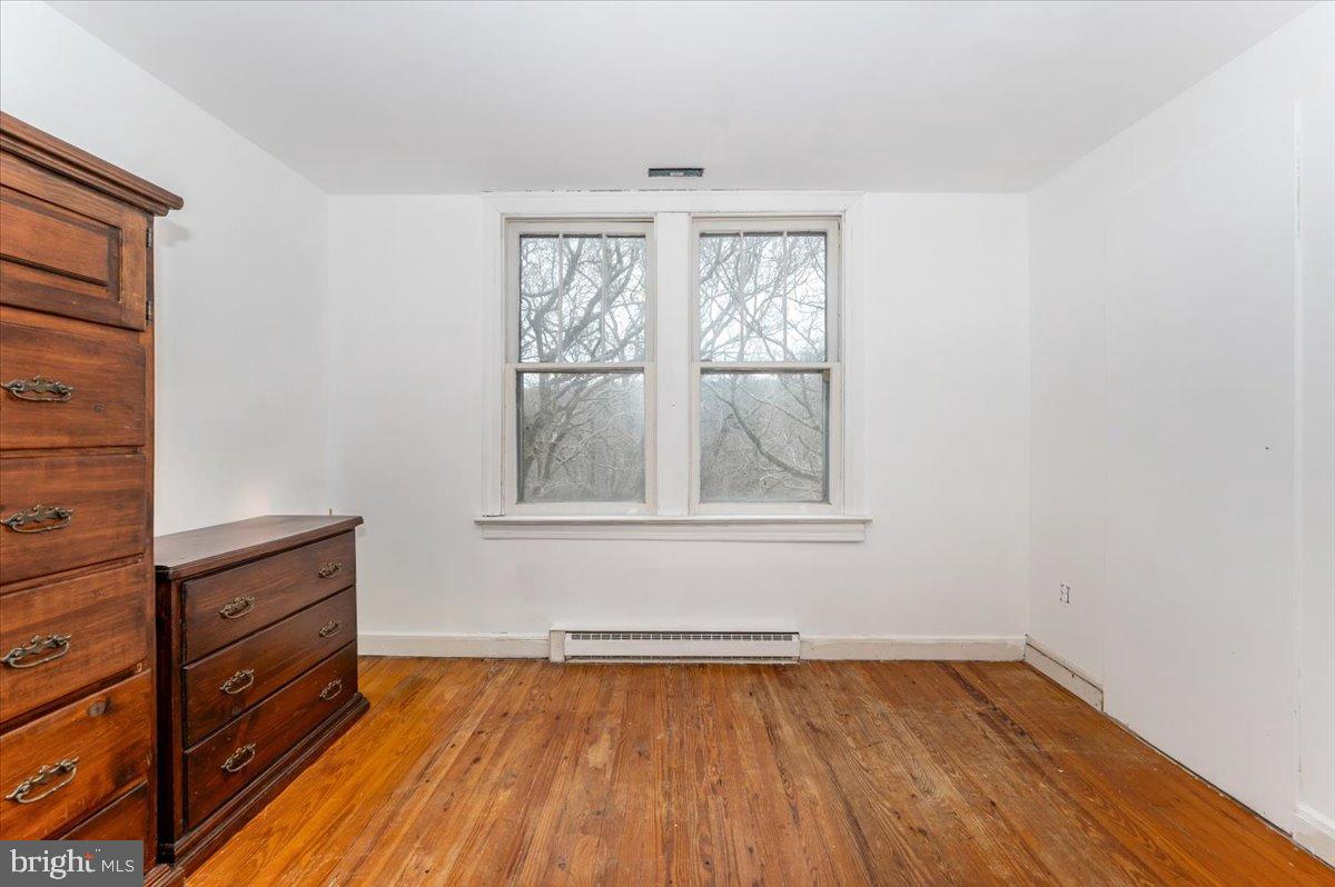 10891 Bethesda Church Road Damascus, MD 20872 - Photo 21 of 51 wooden floor in an empty room with a window