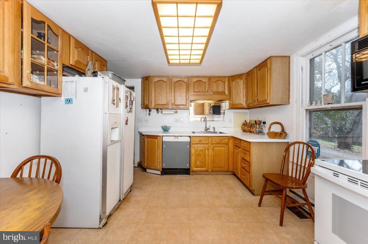 10891 Bethesda Church Road Damascus, MD 20872 - Photo 10 of 51 a kitchen with a sink a window and chairs
