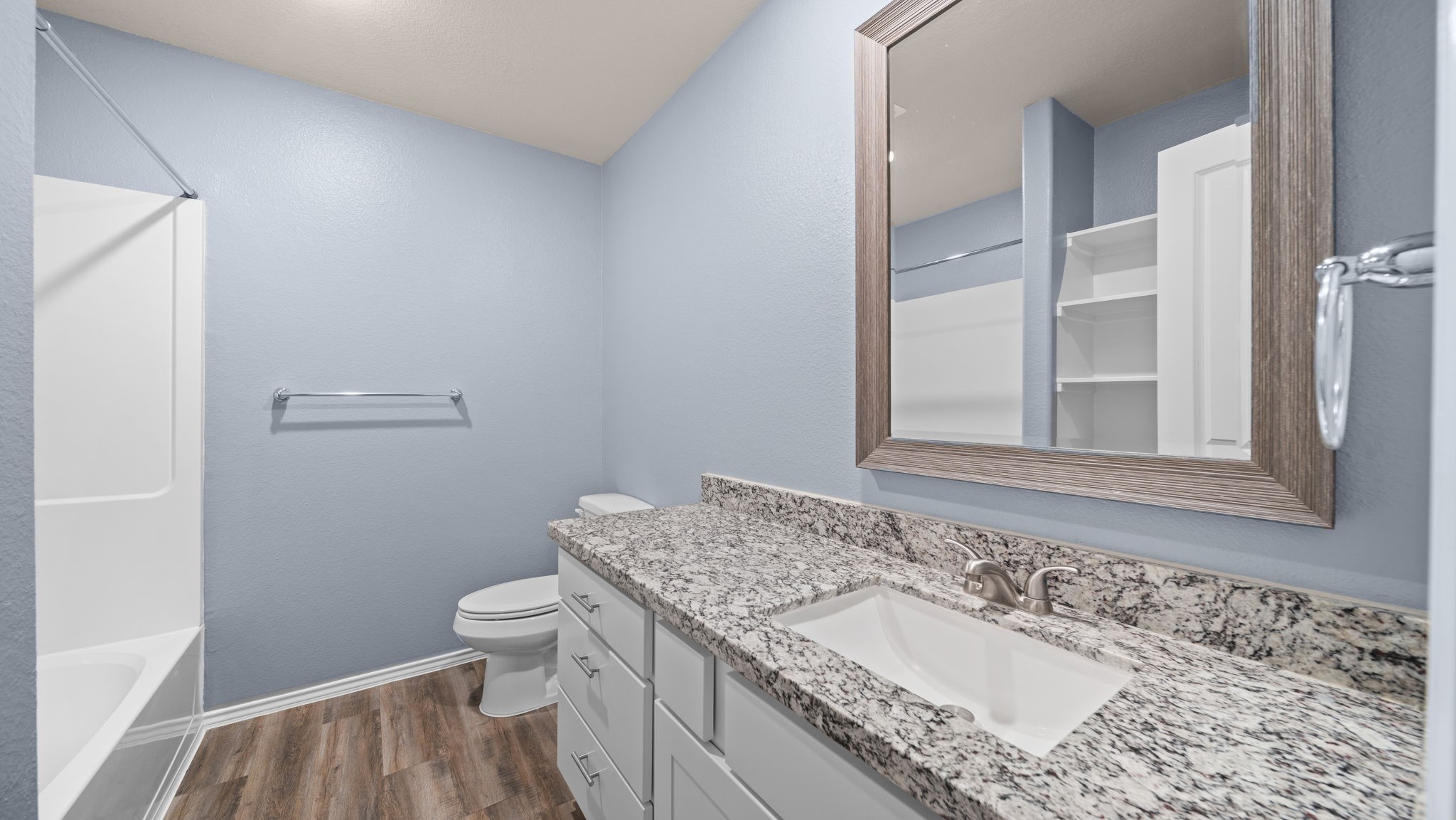 18140 Mail Rte Road Montgomery, TX 77316 - Photo 19 of 26 Stylish secondary bathroom featuring granite countertops, modern cabinetry, and a tub/shower combination.