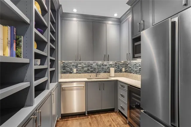a kitchen with stainless steel appliances a refrigerator and a sink
