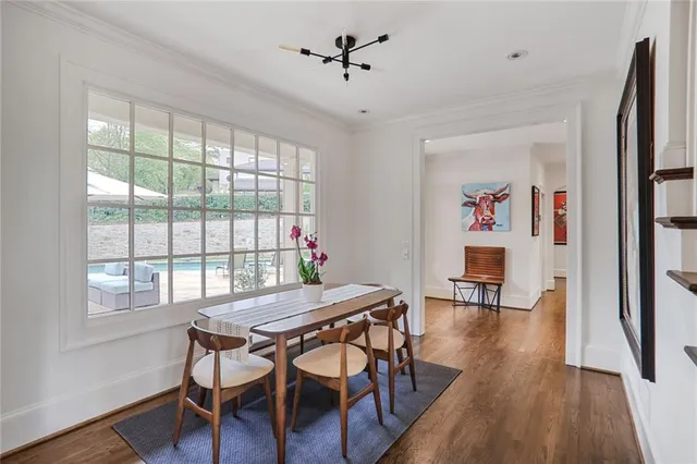 a view of a dining room with furniture window and wooden floor