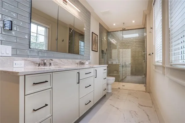 a bathroom with a granite countertop sink mirror and double
