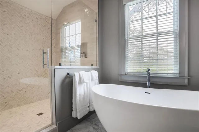 a bathroom with a tub and a shower