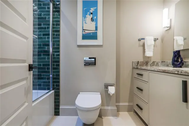 a bathroom with a granite countertop toilet a sink and a bathtub