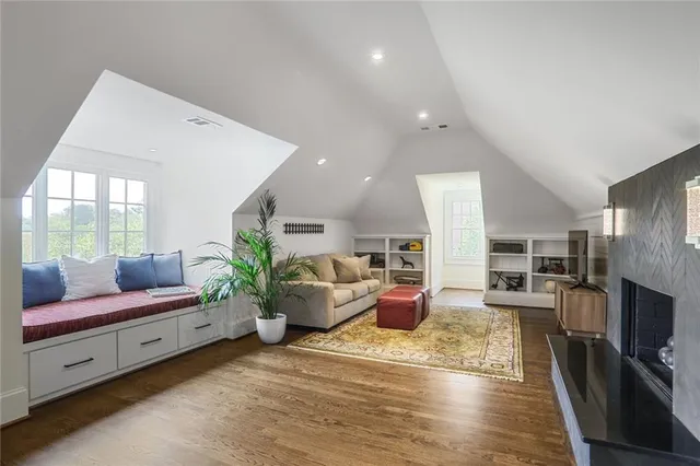 a living room with furniture fireplace and flat screen tv