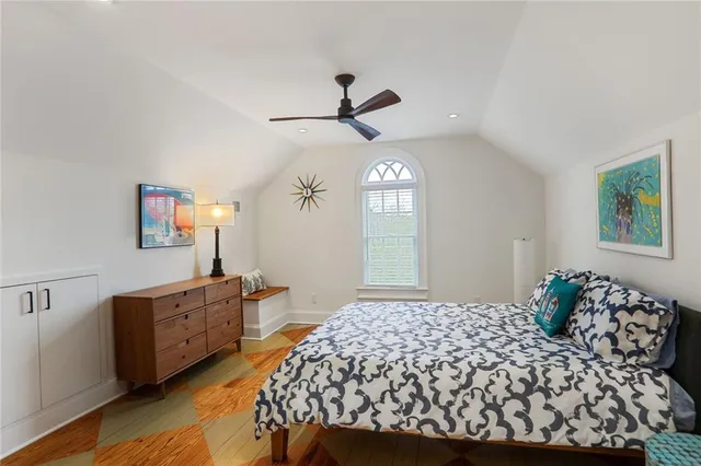 a bedroom with a large bed and a chandelier