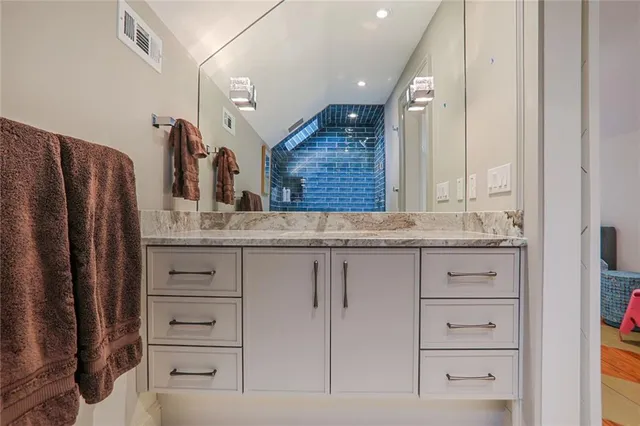 a bathroom with cabinets double vanity and a sink