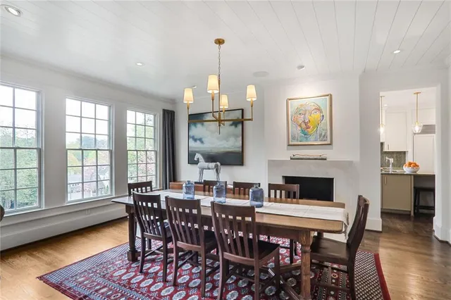 a dining room with furniture a window and wooden floor