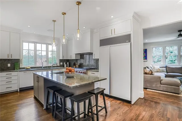 a kitchen with refrigerator cabinets and wooden floor