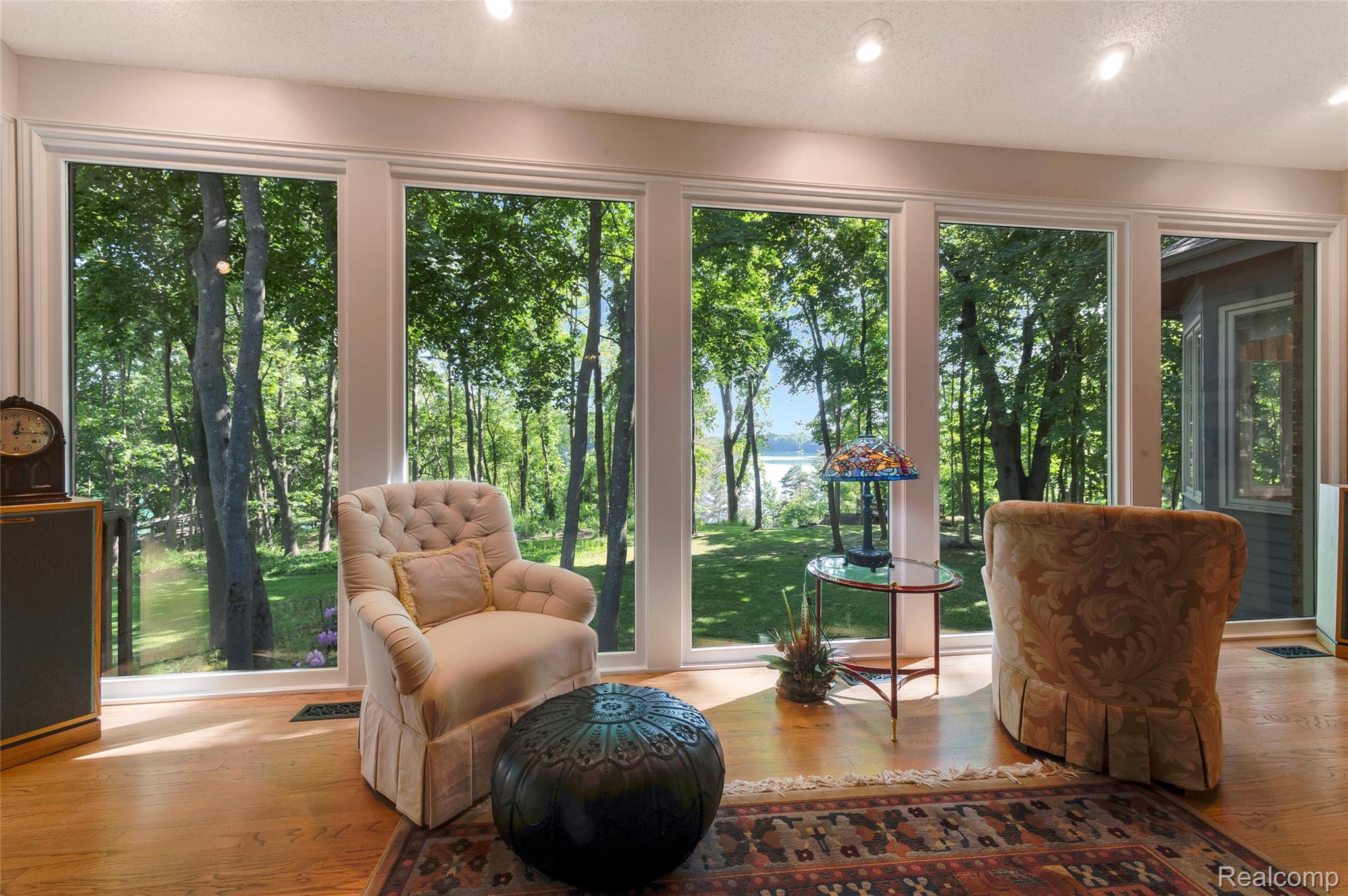 2323 Addaleen Road Highland, MI 48357 - Photo 33 of 70 Floor-to-ceiling windows overlooking a natural landscape and the lake