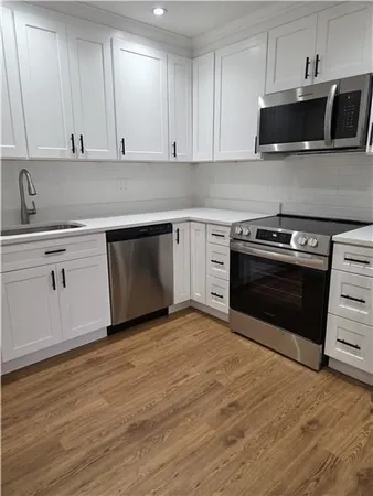 a kitchen with granite countertop a stove and a microwave oven