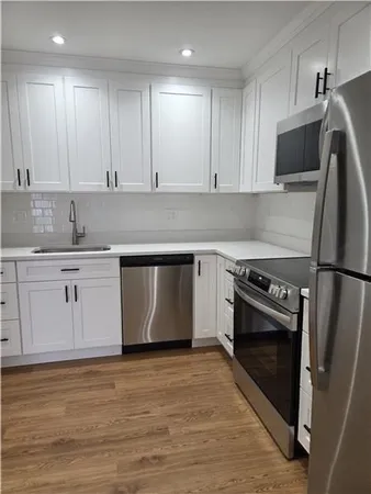 a kitchen with a sink stove and refrigerator