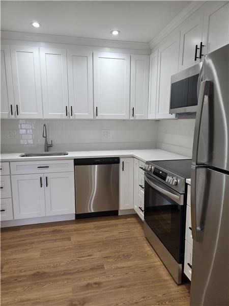 1000 Lexington Street, Unit 36 Waltham, MA 02451 - Photo 2 of 10 a kitchen with a sink stove and refrigerator
