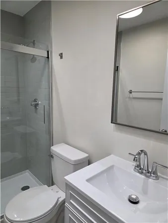 a bathroom with a sink toilet and shower