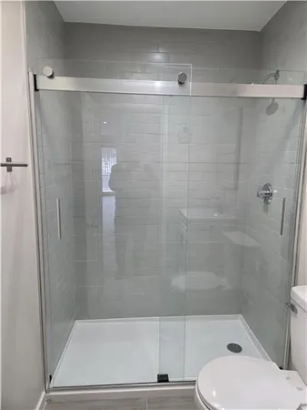 a bathroom with a shower and a toilet