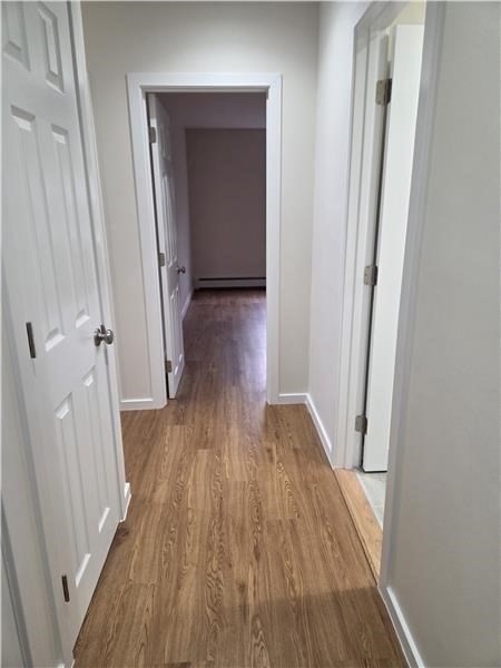 1000 Lexington Street, Unit 36 Waltham, MA 02451 - Photo 9 of 10 a view of a hallway with wooden floor and staircase