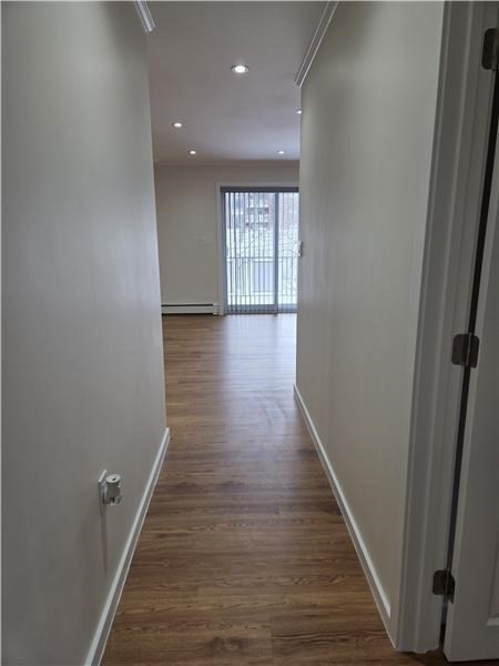 1000 Lexington Street, Unit 36 Waltham, MA 02451 - Photo 10 of 10 a view of a hallway with wooden floor and staircase