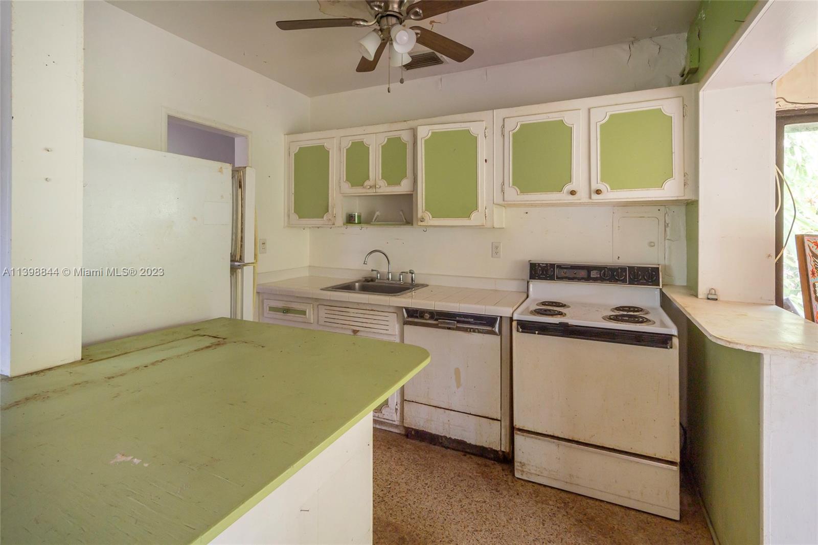 6600 Southwest 45th Street Miami, FL 33155 - Photo 15 of 27 a kitchen with stainless steel appliances granite countertop a stove and a white refrigerator