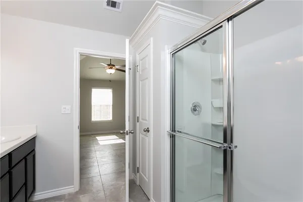 a bathroom with a glass shower door